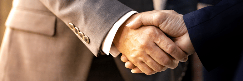 two people shaking hands over mergers and acquisitions