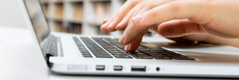 person typing on laptop keyboard