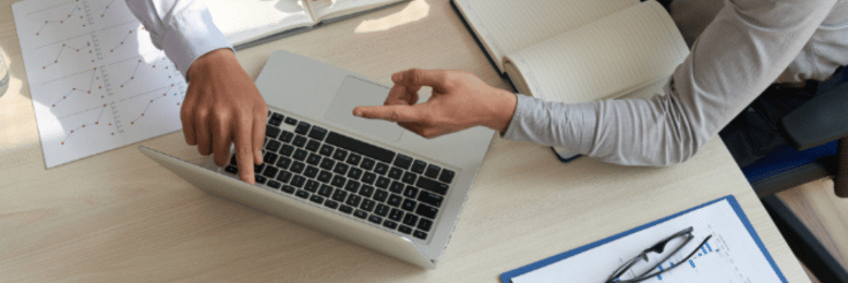 two people discussing things over a laptop