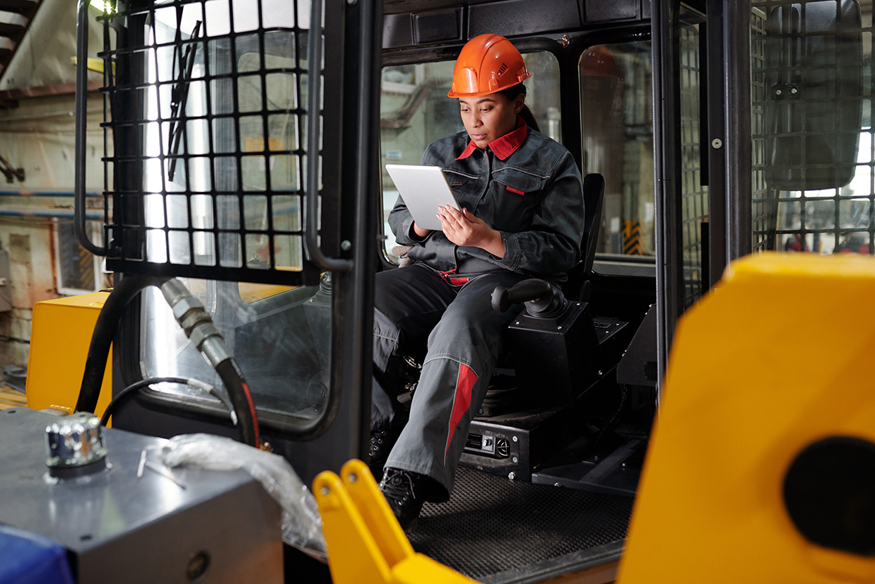 Factory worker scrolling through tablet