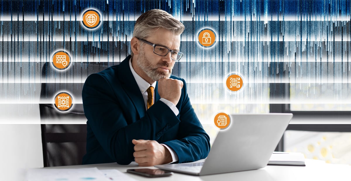 Business executive reviewing layered cybersecurity controls on laptop, illustrating multi-layer cyber defense strategy limits.