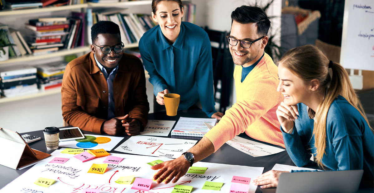 IT team collaborating on project planning to demonstrate MSP project management habits that prevent costly delays.