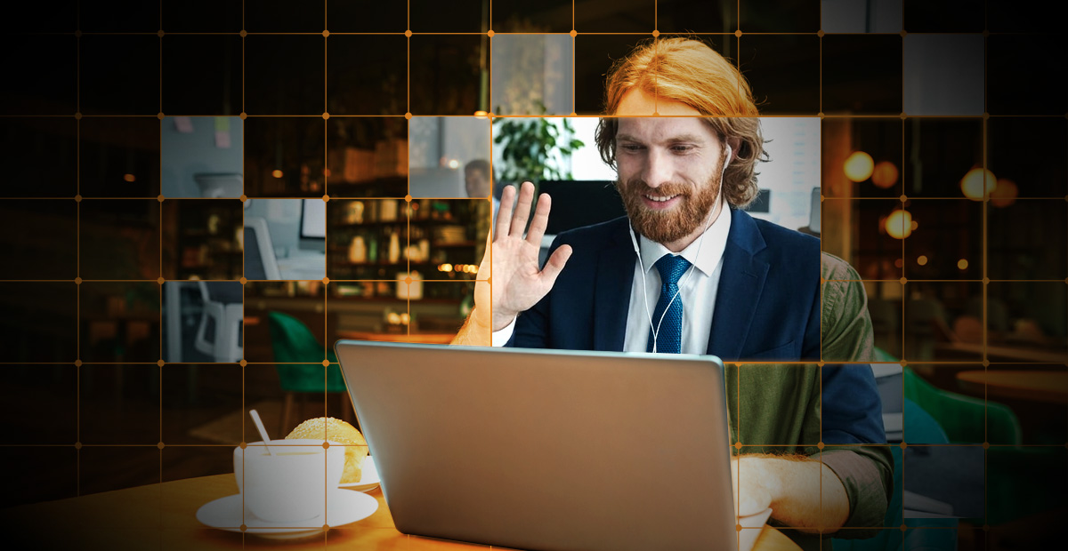 Candidate on video interview waving on laptop, highlighting deepfake hiring fraud risks and secure recruiting process controls.