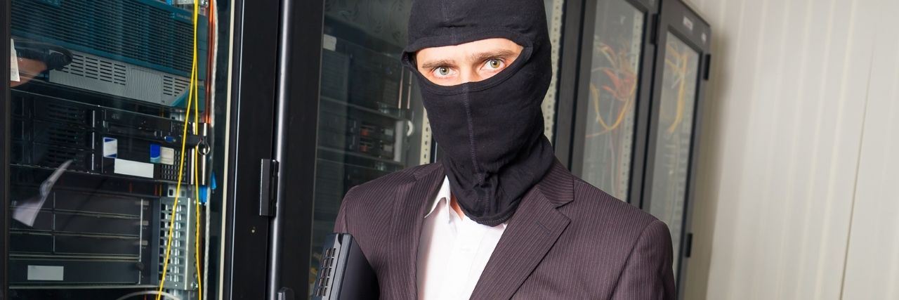 An employee in a hooded mask downloading unauthorized app