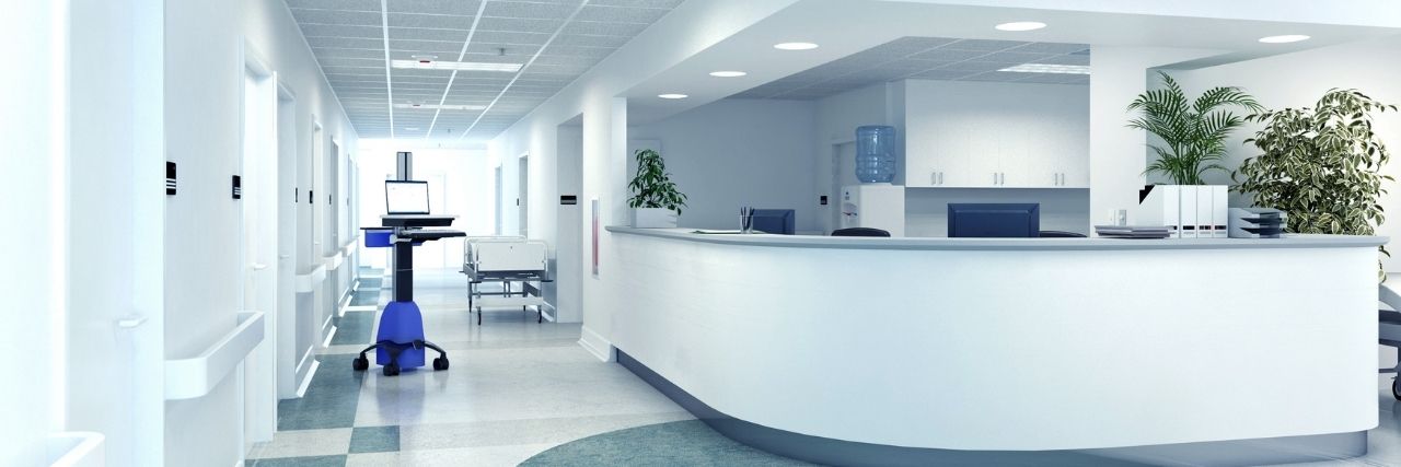 An empty hospital hallway with a nurse's station that suffered from a data breach