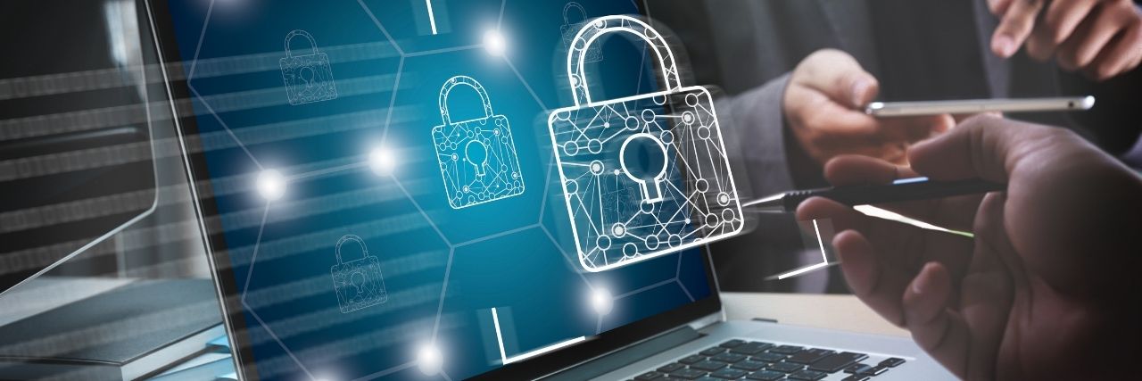 a person pointing on a laptop practicing best data security practices for their business