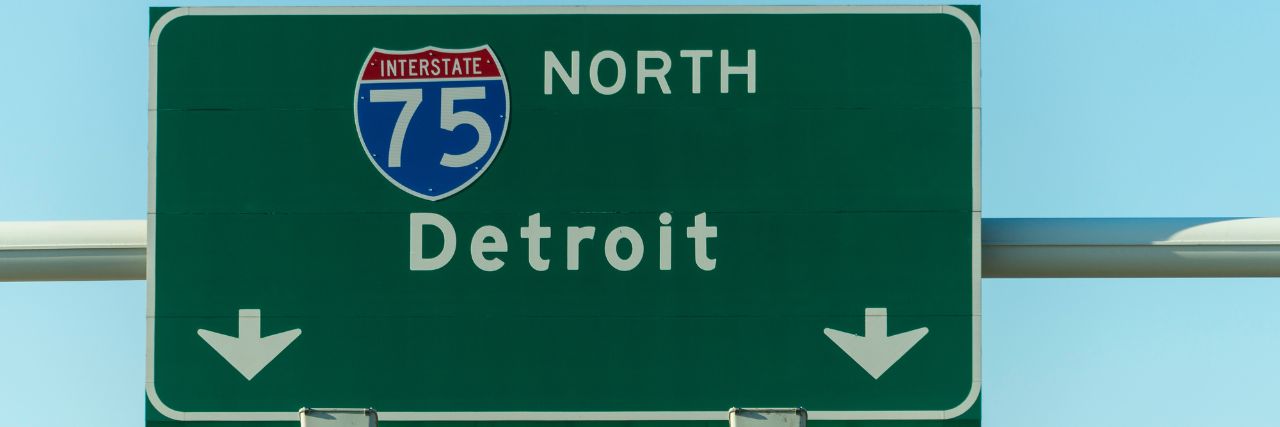 a highway signage leading to Detroit
