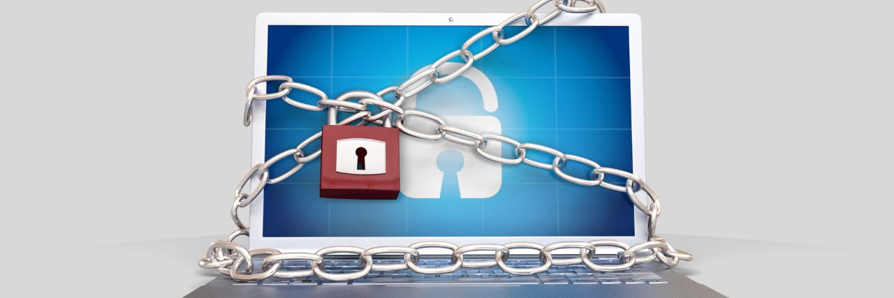 A laptop chained and locked representing a ransomware 