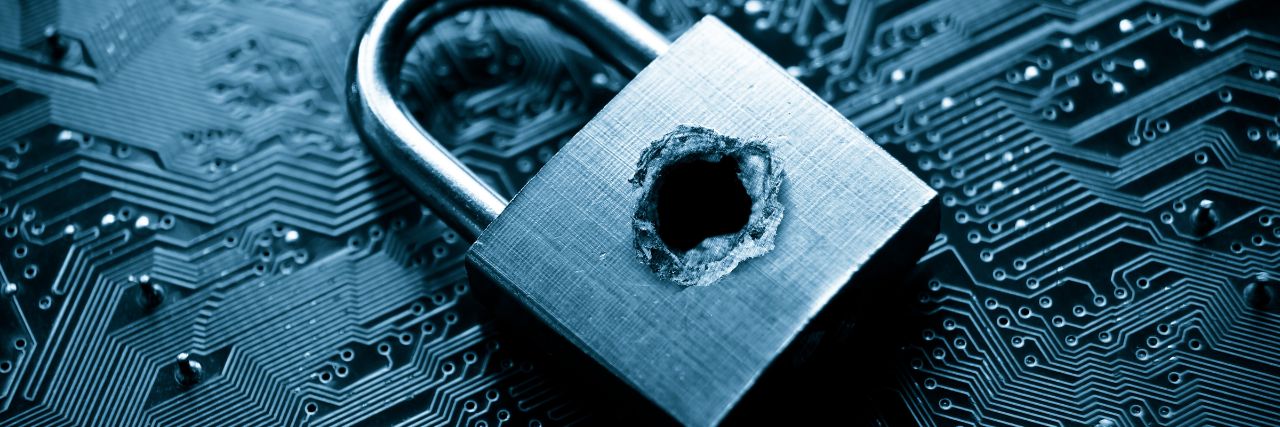a bullet hole in a padlock on top of data