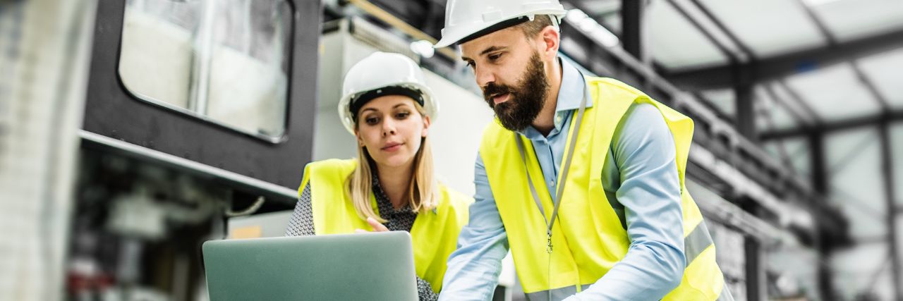 two employees in the manufacturing industry in front of the laptop