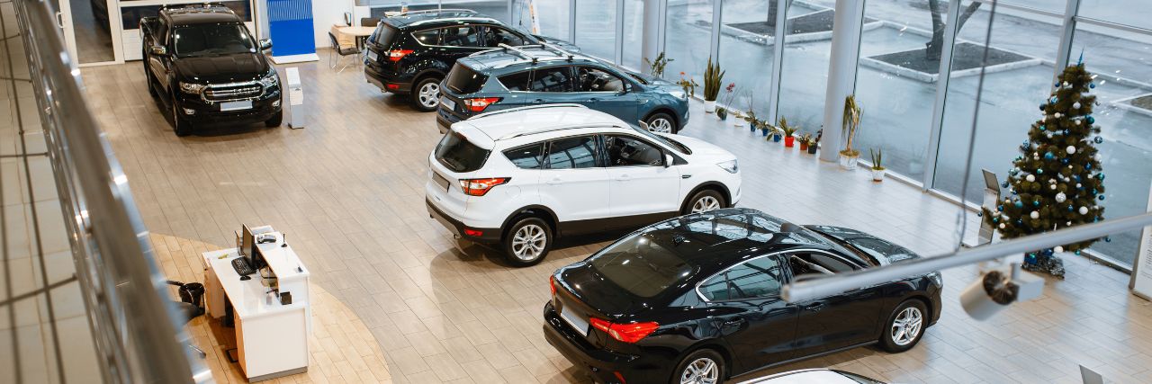 multiple cars displayed inside an auto dealership
