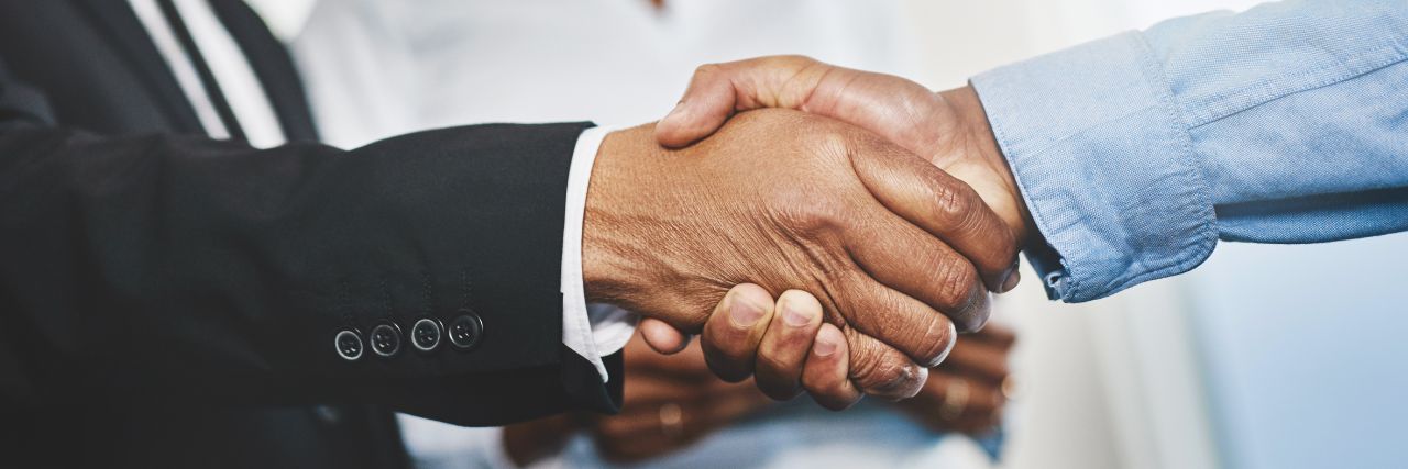 a person shaking the hands of another person during onboarding