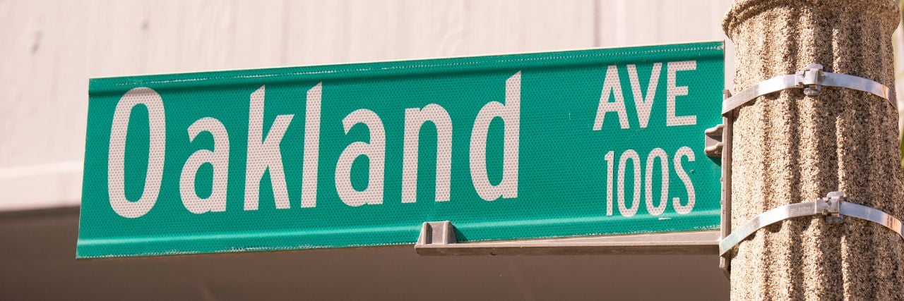oakland street sign representing co-managed it companies in oakland