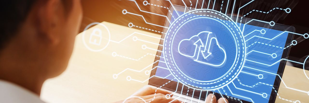 a person using a laptop with cloud computing