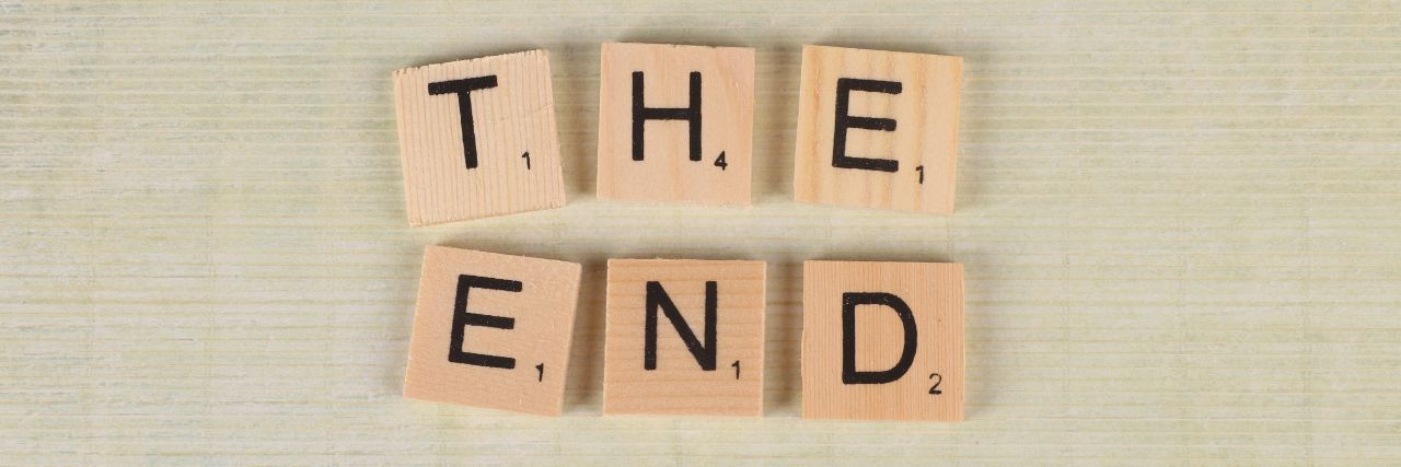 the end written using scrabble wooden tiles