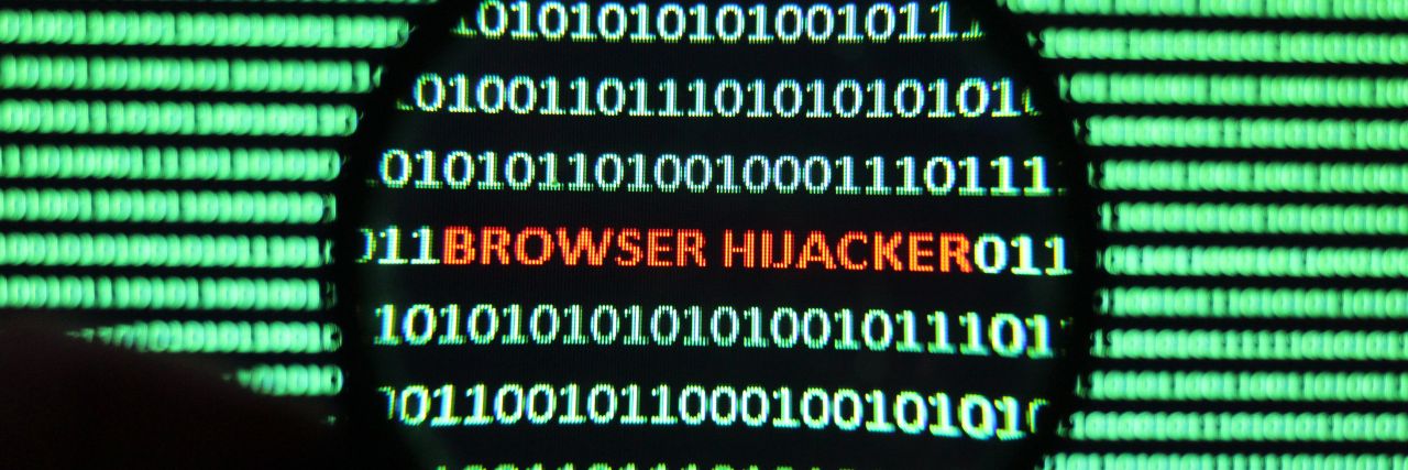 browser hijacker hidden in code with a magnifying glass
