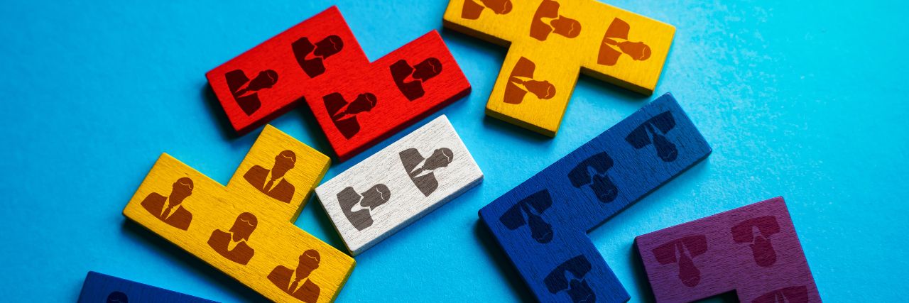 blocks with pictures of employees on them signifying IT department restructure
