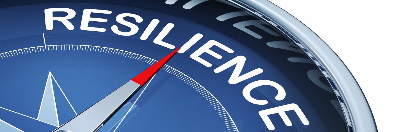 a compass pointing to the word resilience