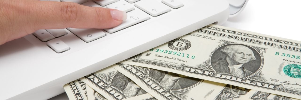 money coming out of a laptop