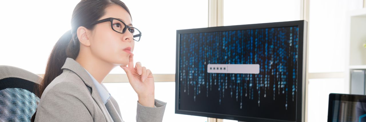 a person sitting in front of a computer evaluating a cyber insurance agent
