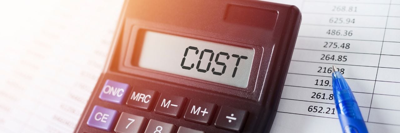 the word cost written on a calculator