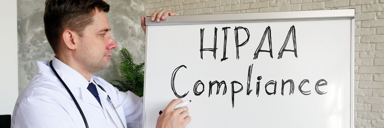 a doctor writing HIPAA compliance on a white board