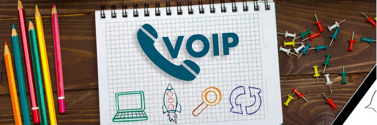 a VOIP doodled in a spring notebook on a desk with other icons