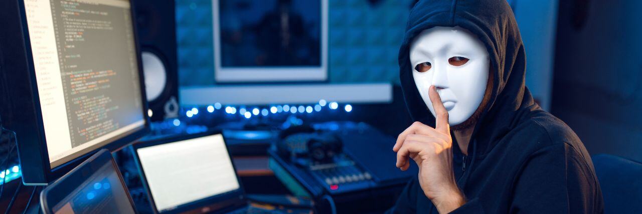 a hacker making a keep silent sign while hacking a company