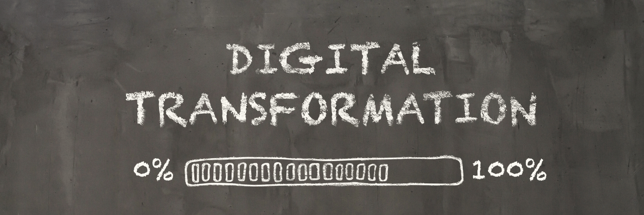 A blackboard with digital transformation written on it as it reached 100%