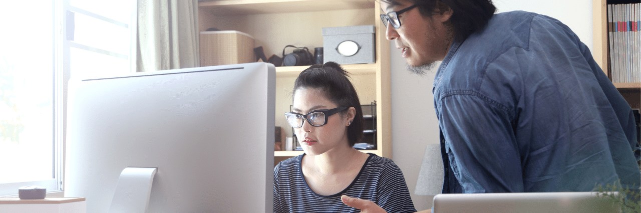 A person having an IT problem being assisted by an IT guy