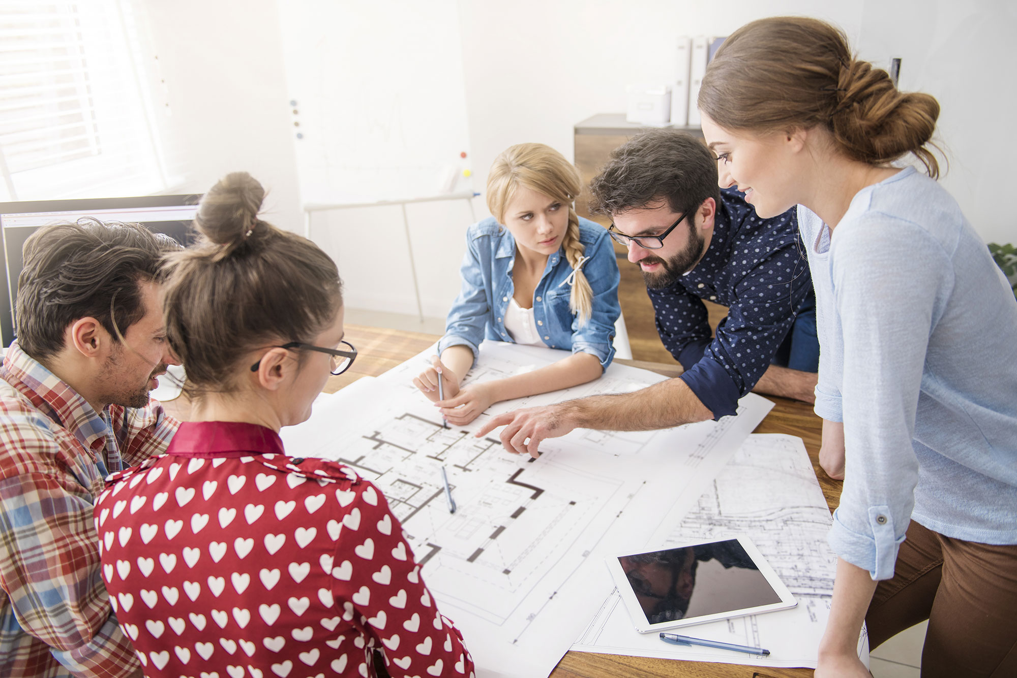 archi_whenyes-(Coworkers-at-office-with-architecture-plans-and-a-computer)