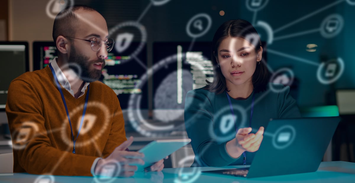 IT and compliance professionals reviewing FTC Safeguards Rule cybersecurity requirements on laptop in secure office setting.