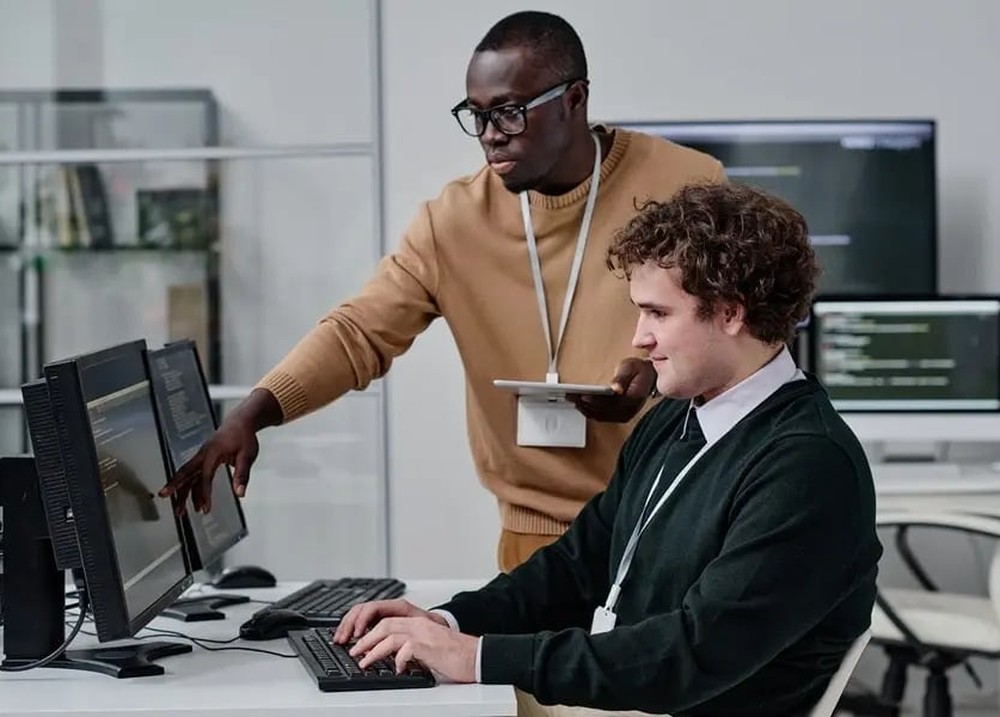 An ITS team reviewing data and reporting on screen