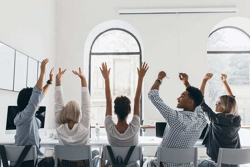 ITS employees talking at a shared workspace
