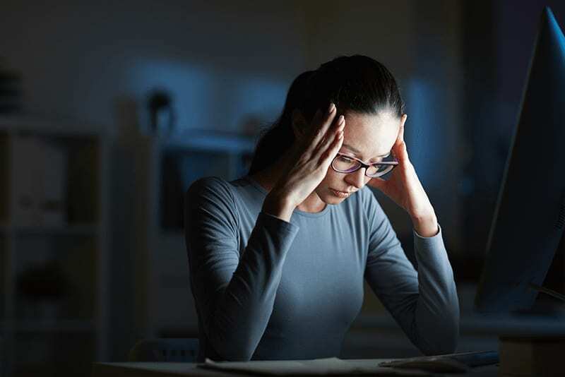 An employee burned out at a desk late at night