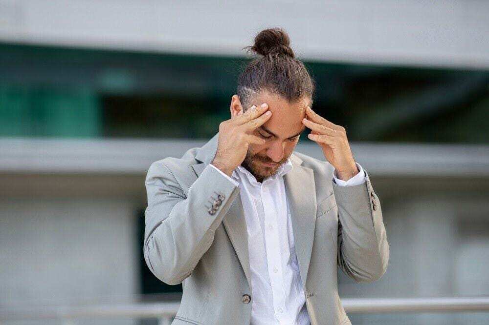 A frustrated business owner at a laptop