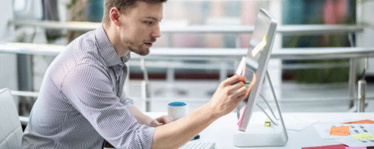 Designer comparing monitors at a workstation
